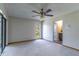 Spacious bedroom with ceiling fan, sliding glass doors, and access to a bathroom at 400 Magnolia Oak Dr, Longwood, FL 32779