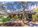 Ranch-style home with mature landscaping and a large oak tree in the front yard at 400 Magnolia Oak Dr, Longwood, FL 32779