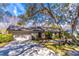 Ranch style home with attached garage and mature trees at 400 Magnolia Oak Dr, Longwood, FL 32779