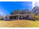 Single story home with screened porch and lush landscaping at 400 Magnolia Oak Dr, Longwood, FL 32779