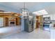 Bright kitchen with stainless steel appliances and views into the living room with a stone fireplace at 400 Magnolia Oak Dr, Longwood, FL 32779