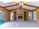 Living room features a stone fireplace, wood paneling, and vaulted ceilings with skylights at 400 Magnolia Oak Dr, Longwood, FL 32779