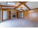 Spacious living room with a stone fireplace, wood paneling, and vaulted ceilings at 400 Magnolia Oak Dr, Longwood, FL 32779