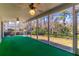 Relaxing screened porch with green carpeting and ceiling fans at 400 Magnolia Oak Dr, Longwood, FL 32779