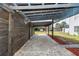 Covered patio area with dark wood pergola and brick pavers at 4103 Quail Nest Ct, St Cloud, FL 34772