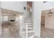 Modern staircase with white railings and gray wood-look flooring at 4103 Quail Nest Ct, St Cloud, FL 34772