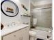 Clean bathroom with a tub shower, vanity, and decorative accents at 421 High Tide Ln, Daytona Beach, FL 32124