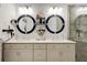 Double vanity bathroom with large mirrors and a walk-in shower at 421 High Tide Ln, Daytona Beach, FL 32124