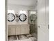 Elegant bathroom with double vanity, large mirrors, and a walk-in shower at 421 High Tide Ln, Daytona Beach, FL 32124
