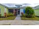 Charming cottage exterior with a screened porch and landscaped front yard at 421 High Tide Ln, Daytona Beach, FL 32124