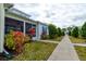 Cottage exterior with walkway and tropical landscaping at 421 High Tide Ln, Daytona Beach, FL 32124