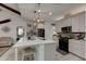 Modern kitchen with island, stainless steel appliances, and white cabinets at 421 High Tide Ln, Daytona Beach, FL 32124