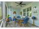 Bright and airy screened porch with table, chairs, and nautical decor at 421 High Tide Ln, Daytona Beach, FL 32124