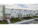 Townhome community featuring multiple units and a parking area at 4447 Scene Ln, Kissimmee, FL 34746