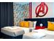 Avengers themed bedroom with twin beds, nightstand, and comic wallpaper at 4447 Scene Ln, Kissimmee, FL 34746