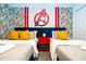 Avengers themed bedroom with twin beds, nightstand, and comic wallpaper at 4447 Scene Ln, Kissimmee, FL 34746