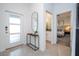 Modern entryway with white door, tile floor, and a view of bedroom and bath at 4447 Scene Ln, Kissimmee, FL 34746