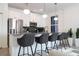 Modern kitchen with white cabinets, stainless steel appliances, and island seating at 4447 Scene Ln, Kissimmee, FL 34746