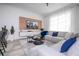 Spacious living room with sectional sofa, large TV, and wood feature wall at 4447 Scene Ln, Kissimmee, FL 34746