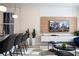 Open living space with kitchen and a large TV at 4447 Scene Ln, Kissimmee, FL 34746
