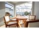 Screened patio with wood table, chairs, grill, and pool view at 4447 Scene Ln, Kissimmee, FL 34746