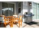 Outdoor patio with wood table, chairs, and grill at 4447 Scene Ln, Kissimmee, FL 34746
