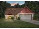 Inviting home exterior featuring a two-car garage and well-manicured lawn at 452 N Pine Meadow Dr, Debary, FL 32713