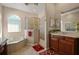 Bright bathroom with tub and shower, double vanity sinks and ample counter space at 4943 Cains Wren Trl, Sanford, FL 32771