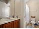 Functional bathroom featuring a vanity with good storage and a well lit shower and toilet at 4943 Cains Wren Trl, Sanford, FL 32771