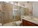 Well-lit bathroom features a glass-enclosed shower and vanity with sink at 4943 Cains Wren Trl, Sanford, FL 32771