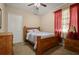 Bedroom featuring a bed, closet, dresser, carpet and red curtains at 4943 Cains Wren Trl, Sanford, FL 32771