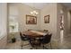 Cozy dining area with round wood table and natural light from nearby window at 4943 Cains Wren Trl, Sanford, FL 32771