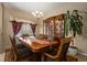 Formal dining room with wooden table set, chandelier lighting, china cabinet, and window at 4943 Cains Wren Trl, Sanford, FL 32771