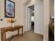 Hallway featuring an ornate wooden table and painting leading to the Primary bedroom at 4943 Cains Wren Trl, Sanford, FL 32771