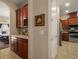 Kitchen view featuring wooden cabinetry, stainless steel appliances, and tile flooring at 4943 Cains Wren Trl, Sanford, FL 32771