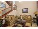 Comfortable living room with staircase access, plush seating, and stylish decor, perfect for relaxation at 4943 Cains Wren Trl, Sanford, FL 32771
