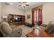 Inviting living room featuring comfortable seating, a ceiling fan, and ample natural light at 4943 Cains Wren Trl, Sanford, FL 32771