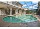 Backyard pool with a screened enclosure and an adjacent patio area at 4943 Cains Wren Trl, Sanford, FL 32771