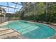 Screened in pool with blue tiling and surrounding concrete deck at 4943 Cains Wren Trl, Sanford, FL 32771