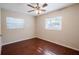Bright bedroom featuring wood-look floors and natural light from two large windows at 5112 Londonderry Blvd, Orlando, FL 32808
