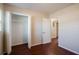 Bright bedroom featuring wood-look floors, closet with open doors and a view of the home's interior at 5112 Londonderry Blvd, Orlando, FL 32808