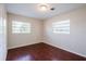 Bedroom with wood-look floors and natural light from two large windows at 5112 Londonderry Blvd, Orlando, FL 32808