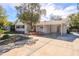 Front exterior of a single-story home featuring a convenient carport and well-lit driveway at 5112 Londonderry Blvd, Orlando, FL 32808