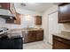 Kitchen with granite countertops, wood cabinets, and sleek black appliances at 5112 Londonderry Blvd, Orlando, FL 32808