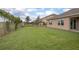 Large backyard with a fence, lush green grass, and plenty of space for outdoor activities at 523 Lazio Cir, Debary, FL 32713