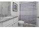 Bright bathroom featuring a granite countertop and a shower with a striped curtain at 523 Lazio Cir, Debary, FL 32713