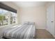 Cozy bedroom featuring a bed, a window with a view, and a closet door at 523 Lazio Cir, Debary, FL 32713