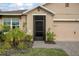 Charming home entrance with a screen door, a well-manicured lawn and an attached garage at 523 Lazio Cir, Debary, FL 32713