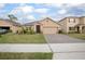 A cozy single-Gathering home with a well-maintained lawn and a two-car garage at 523 Lazio Cir, Debary, FL 32713