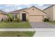 Charming single-story home with manicured lawn, complemented by mature landscaping and a brick-paved driveway at 523 Lazio Cir, Debary, FL 32713